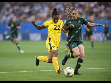
Mireya Grey (left) of the Reggae Girlz goes on the attack under pressure from Australia’s Karly Roestbakken in the Jamaica vs Australia fixture of the FIFA Women’s World Cup 2019 at Stade des Alpes in Grenoble, France, on Tuesday, June 18, 2019.