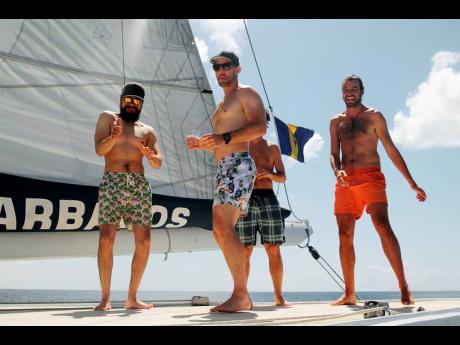 These Colombian passengers (from left) Diego Ortiz, Juan Pablo Añez, Guido Piotrkowski and Christian Byfield, actually of Jamaican roots, take to the roof of the ‘Spirit of Barbados’ Catamaran to wuk up. 