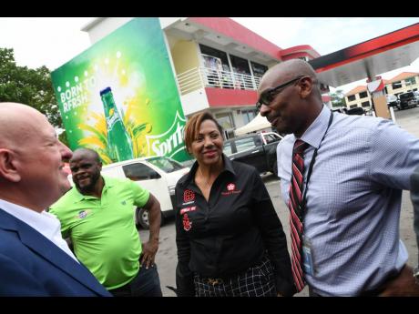 
Petrol dealer Annette Wong-Lee is flanked by (from left) GB Energy Jamaica CEO Mauricio Pulido, Managing Director of BucMars Inc Dwight Morgan, and NCB Oxford Place Branch Manager Dean Simpson, at the opening of her Texaco station at 94M Old Hope Road in Kingston, on Wednesday, July 31, 2019.