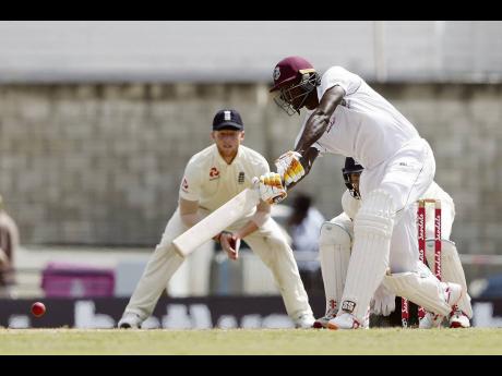 Windies’ captain Jason Holder (right) plays a shot against England during day three of their first Test match, at the Kensington Oval in Bridgetown, Barbados earlier this year.
