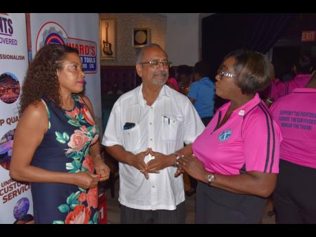 Dr Delroy Fray, clinical coordinator at the Cornwall Regional Hospital, talks with executive director of the Jamaica Cancer Society, Yulit Gordon (left), and Audrey Watson, project coordinator, Kiwanis Club of Providence 5K RUN and Walk, during the launch of the event at the Hard Rock Café in Montego Bay on Thursday.