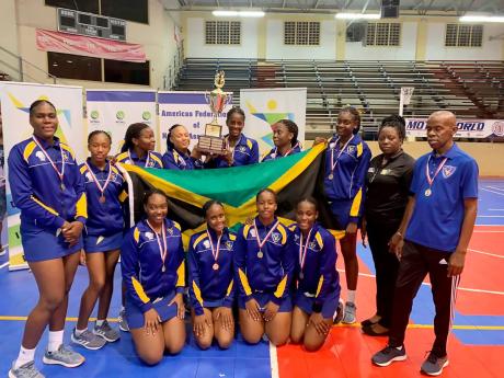 
Members and support staff of the Gaynstead High School netball team pose with their trophy after capturing the Americas Federation of Netball Association Champion of Champions title in St Maarten. 