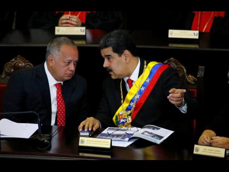 In this January 2019 file photo, Venezuelan President Nicolas Maduro (right), speaks with Constitutional Assembly President Diosdado Cabello at the Supreme Court during an annual ceremony that marks the start of the judicial year in Caracas, Venezuela. 