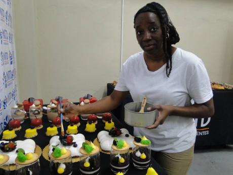 Natalee Scarlette, sales executive, puts the finishing touches on mousse cakes made by NTD Ingredientes.
