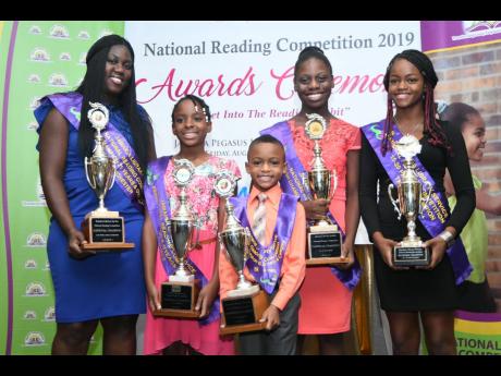 The national champions for the five age groups in the Jamaica Library Service’s National Reading Competition pose with their awards at yesterday’s presentation ceremony at The Jamaica Pegasus hotel. From left are Sanikia Powell-Morgan of Manchester, Natajia Newton of St James, Travis Kerr of St James, Jo’Anna Hill of St James, and Kaliesha Gager of Trelawny.