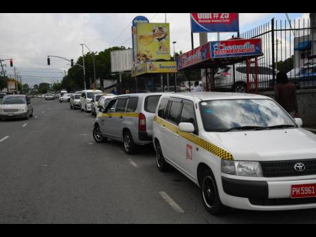 Taxi operators on Hope Road, St Andrew.