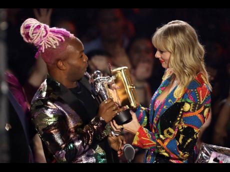 Todrick Hall (left) and Taylor Swift accept the video for good award for ‘You Need to Calm Down’ at the MTV Video Music Awards at the Prudential Center on Monday.