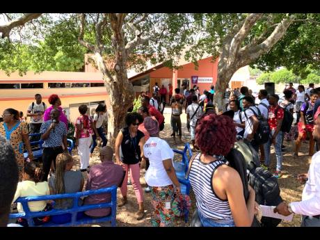 Students and staff of the Edna Manley College of the Visual and Performing Arts disperse after a meeting to discuss updates on the sexual harassment scandal rocking the educational institution on Tuesday.