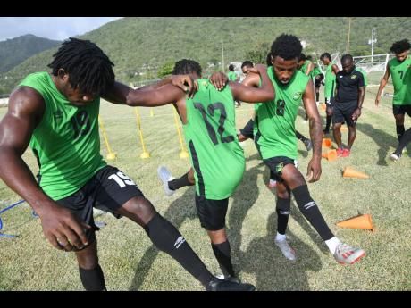 Several local-based players go through their paces during a Reggae Boyz training camp at the UWI/JFF Centre of Excellence on Tuesday. 
