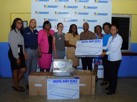 Staff at the Seaview Gardens Health Centre accepting much-needed new equipment from Massy Group.