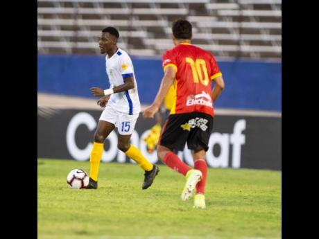 Waterhouse FC’s André Fletcher (left) takes control of the ball as CS Herediano’s Yeltsin Tejeda advances during their first leg Scotiabank Concacaf League game at the National Stadium on Thursday, August 22. 