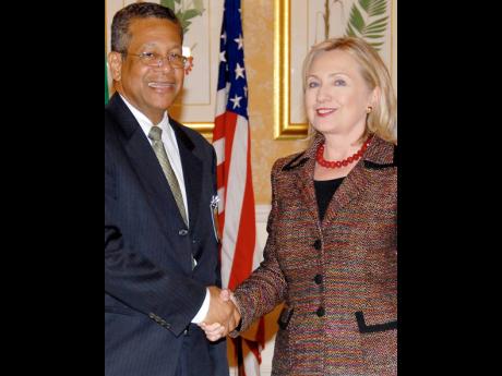 Then Foreign Affairs Minister Dr Kenneth Baugh greets US Secretary of State Hillary Clinton in this 2011 photo.