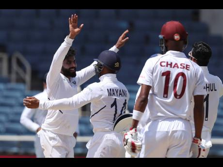 India’s Ravindra Jadeja celebrates taking the wicket of West Indies’ Roston Chase during day four of the second Test cricket match at Sabina Park in Kingston, Jamaica, yesterday.