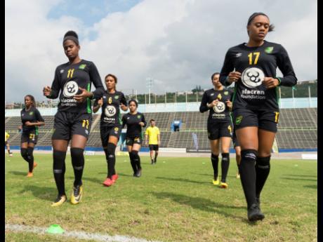 Reggae Girlz Khadija Shaw (foreground left) and Allyson Swaby (foreground right), along with other members of the national senior women’s football team, go through a training session at the National Stadium in Kingston on Friday, January 18, 2019. 
