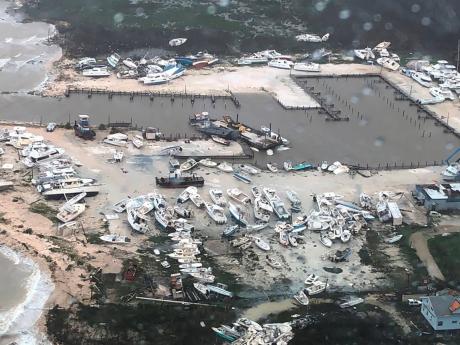 In this photo taken on Monday, boats litter the area around a marina in The Bahamas after they were tossed around by Hurricane Dorian. At least sevendeaths have been reported. 