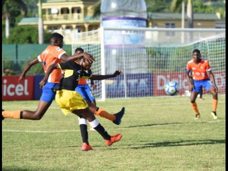 
Lennon High’s Gowain Austin (left) tackles the ball from his opponent, Clarendon College’s Kodrick Granville (right), who takes a shot under pressure during the ISSA/WATA daCosta Cup match at the Montego Bay Sports Complex between Clarendon College and Lennon High yesterday. The game ended 1-1