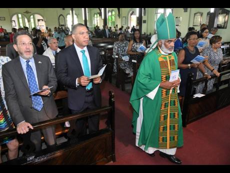 The Reverend Dr Robert Thompson (right), bishop of Kingston, enters while Prime Minister Andrew Holness (second left) and Joseph M. Matalon, chairman of The RJRGLEANER Communications Group, look on during The Gleaner Company (Media) Limited’s 185th Anniversary Church Service held yesterday at St George’s Anglican Church in Kingston. 