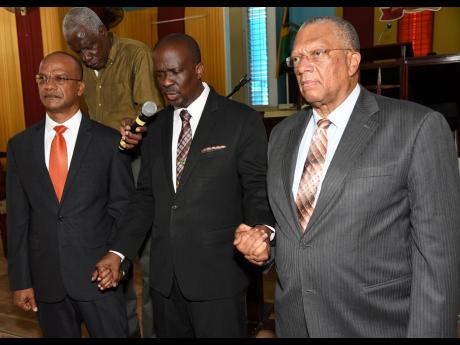 
The Reverend Devon Dick (centre), pastor of the Boulevard Baptist Church, prays for Dr Peter Phillips (right), president of the People’s National Party (PNP), and Peter Bunting (left) during a Unity and Healing Service, which was held at the church yesterday.