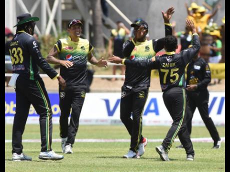 Members of the Jamaica Tallawahs celebrate the fall of a Barbados Tridents wicket during their Caribbean Premier League game at Sabina Park in Kingston yesterday. 
