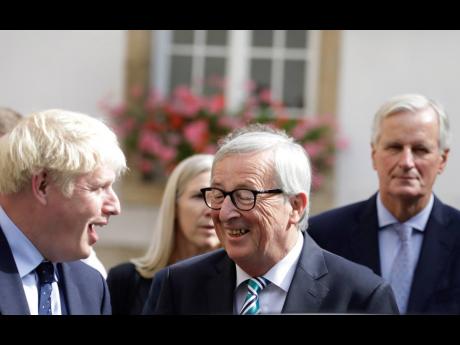 European Commission President Jean-Claude Juncker, center, speaks with British Prime Minister Boris Johnson, left, after a meeting in Luxembourg, Monday, Sept. 16, 2019. British Prime Minister Boris Johnson held his first meeting with European Commission President Jean-Claude Juncker on Monday in search of a longshot Brexit deal. (AP Photo/Olivier Matthys)