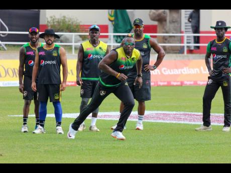 Jamaica Tallawahs all-rounder André Russell (foreground) trains with other members of the team at Sabina Park yesterday. 