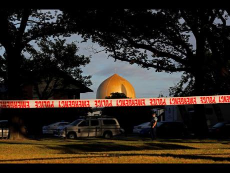 In this March 17, 2019, file photo a police officer stands guard in front of the Masjid Al Noor mosque in Christchurch, New Zealand, where one of two mass shootings occurred. 