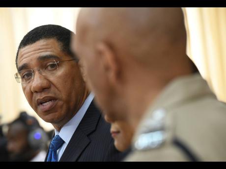Prime Minister Andrew Holness  looks at  Commissioner of Police Major General Antony Anderson as he announced a state of public emergency in the parishes of Clarendon and St Catherine at Jamaica House on Thursday, September 5.