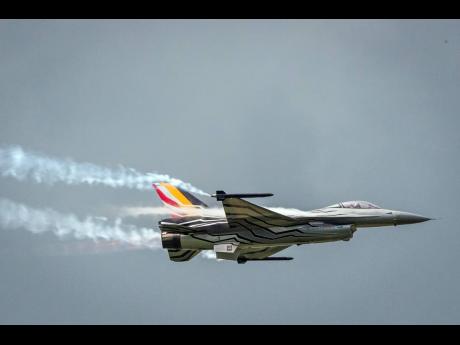 In this May 18, 2016 file photo, a Belgian F-16 fighter jet flies over Florennes Military Airbase in Florennes, Belgium. 