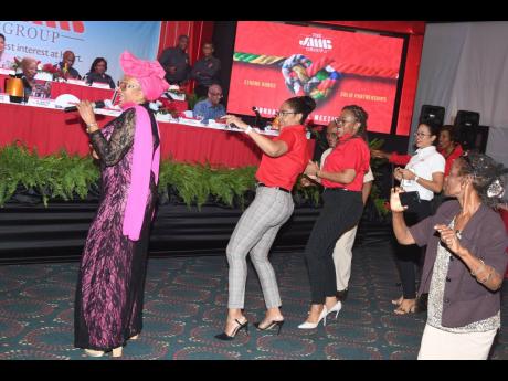 Marcia Griffiths (left), international reggae songbird, had JMMB Group team members and shareholders dancing to one of her classics, ‘Electric Boogie’ 