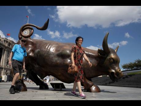 
Visitors pose for photos near the Bund Bull, a version of the New York Charging Bull sometimes also referred to as the Wall Street Bull in Shanghai, China, on Friday, September 20, 2019. 
