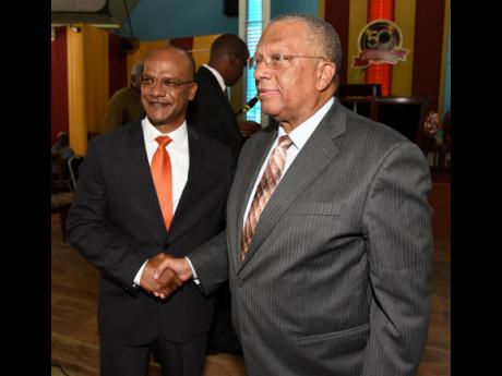 Dr. Peter Phillips (right), president of the People’s National Party, and Peter Bunting 