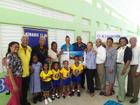 Kiwanians handing over a television set to the Stimulation Plus Early Childhood Development Centre.