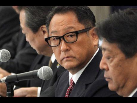 AP 
Akio Toyoda (centre) president and CEO of Toyota Motor Corp, with a group of the Japanese automakers chiefs’ meeting with Japanese Trade Minister Isshu Sugawara on Thursday, September 26, in Tokyo. 