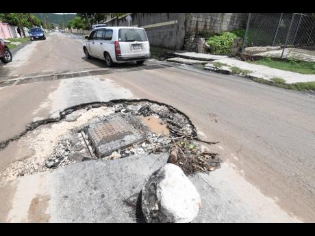 A section of Harbour Drive in Harbour View, St Andrew, has been damaged by floodwaters due to the rainfall currently lashing sections of the island.