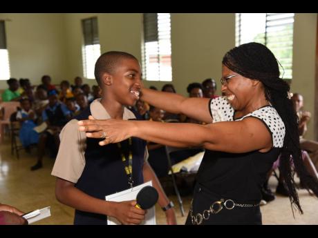 Donette Wynter congratulates her 13-year-old son, Dominic Wynter, as the Munro College student won The Gleaner’s Spelling Bee 2019 championship for the parish of St Elizabeth yesterday.