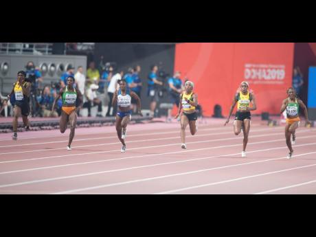 Jamaica's Elaine Thompson (centre) finishes in fourth with a time of 10.93 seconds during the Women's 100m final at the IAAF World Championships at the Khalifa International Stadium in Doha, Qatar on Sunday. The race was won by Thompson's MVP Track Club teammate Shelly-Ann Fraser Pryce (left) in 10.71 seconds.