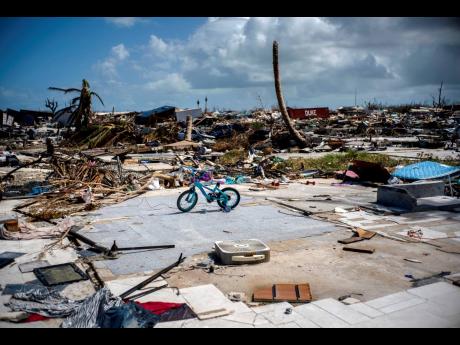An abandoned bicycle stands in a space that used to be a house in a neighbourhood destroyed by Hurricane Dorian in Abaco, Bahamas. Dorian hit the northern Bahamas on September 1, with sustained winds of 185MPH (295KPH), unleashing flooding that reached up to 25 feet (8 metres) in some areas.
