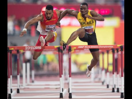 Omar McLeod (right) encroaches on Spain’s Orlando Ortega’s lane, resulting in the Jamaican’s disqualification from the men’s 110m hurdles final at the Khalifa International Stadium during the IAAF World Championships in Doha, Qatar, on Wednesday.