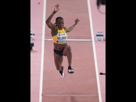Kimberly Williams launches off the runway during an attempt in the qualification round of the women’s triple jump event at the IAAF World Championships in Doha, Qatar, yesterday.