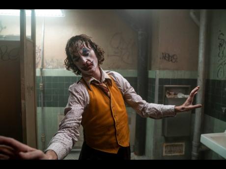 This image released by Warner Bros. Pictures shows Joaquin Phoenix in a scene from the film, ‘Joker’.