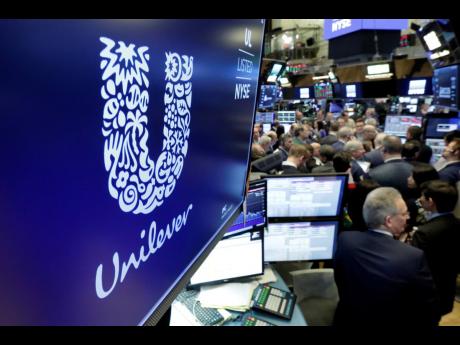 In this 2018  photo, the logo for Unilever appears above a trading post on the floor of the New York Stock Exchange. 