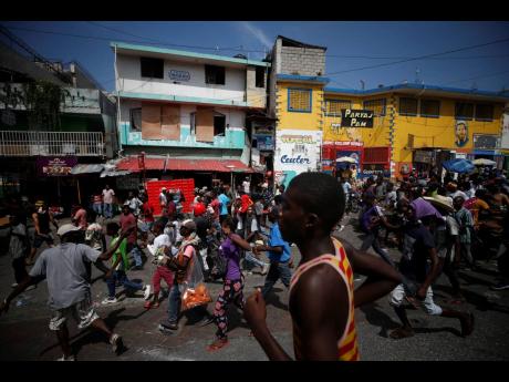 Protesters seeking the resignation of President Jovenel Moïse are joined by market vendors as they march and dance through the streets in Petionville, Port-au-Prince, Haiti, on Wednesday.  Moïse still has more than two years left in his term and says he will not step down despite violent protests that have shuttered businesses and kept two million children from going to school for nearly a month. 