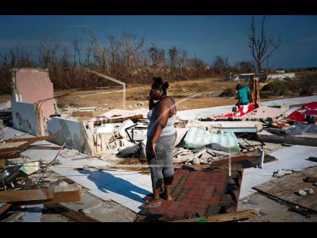 AP 
A woman is overcome with grief as she looks at her house destroyed by Hurricane Dorian in High Rock, Grand Bahama, Bahamas, on Friday, September 6. Constant policing of expanding regulatory regimes are seen as competing with other responsibilities of government, especially in times of disaster.