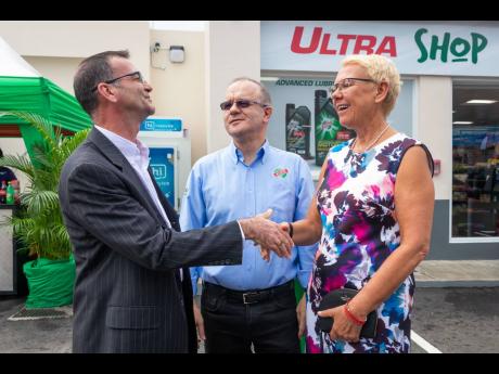 Country manager of Nestlé Jamaica Daniel Caron (left) and head of the European Union Delegation to Jamaica Her Excellency Malgorzata Wasilewska greet each other ahead of the recent grand opening of the RUBiS Liguanea Ultra Shop on Old Hope Road in Kingston. Looking on is CEO of RUBiS Energy Jamaica Ltd Alain Carreau.