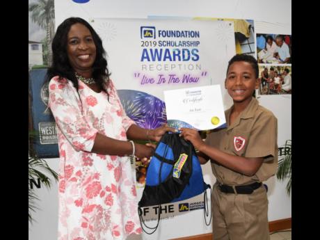 Ari East, student of Campion College, receives his 2019 JN Foundation scholarship certification from Delores Jones, senior vice-president, sales strategist, JN Fund Managers, during a recent reception held at JN Bank’s offices in Kingston. 