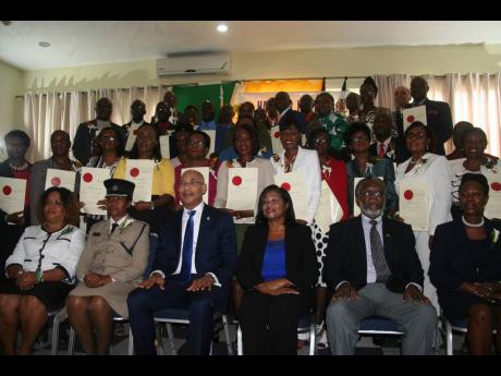 Hanover’s newly installed justices of the peace (standing) pose for the camera with (seated, from left) Sheron Barnes, senior parish judge; Superintendent of police in charge of Hanover, Sharon Beeput; Sir Patrick and Lady Allen; Custos of Hanover David Stair; and parish judge Winsome Henry.