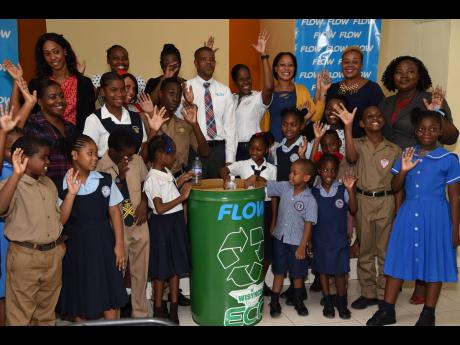 Team members from FLOW Jamaica, Wisynco, teachers and students who were on hand during the donation of 40 drums to be handed over to the 10 schools that partnered with FLOW Jamaica during the Wisynco Eco Challenge Recycle competition. 