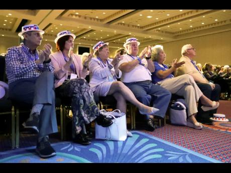 Attendees applaud as they listen to speakers during the Florida Democratic State Convention on Saturday in Lake Buena Vista, Florida. 