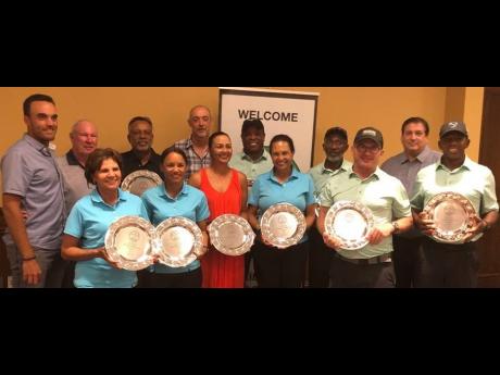 A jubilant Jamaica team celebrates the various trophies and the coveted Ambrose Gouthro country trophy that the nation won for the first time at the Caribbean Golf Association Four-Ball Championships at the PGA National Resort and Spa at Palm Beach Gardens in Florida yesterday.
