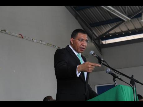 Prime Minister Andrew Holness, leader of the Jamaica Labour Party, addressing an Area Council One meeting at the Girl Guide Association of Jamaica headquarters in St Andrew yesterday. 
